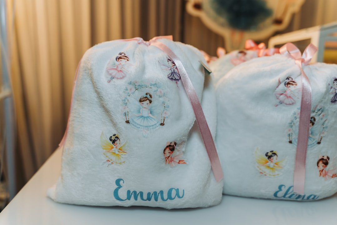 White drawstring bags with ballet dancer designs and names.