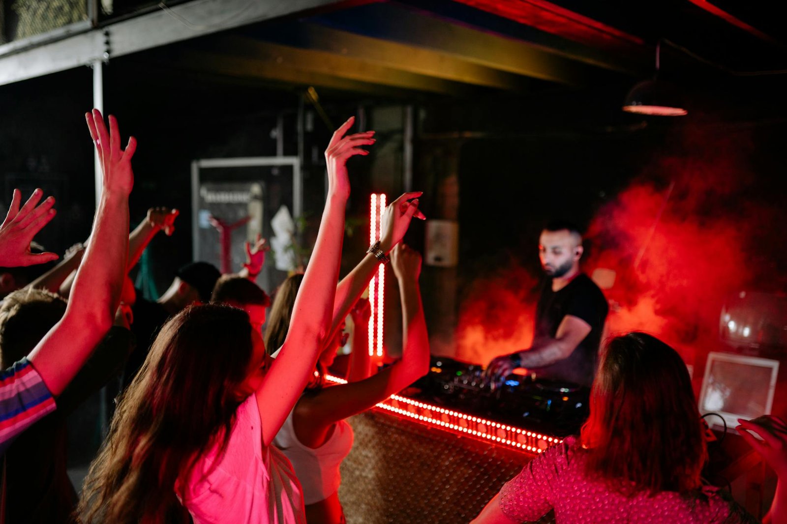 Vibrant nightclub atmosphere with a DJ playing music and crowd enjoying the night.