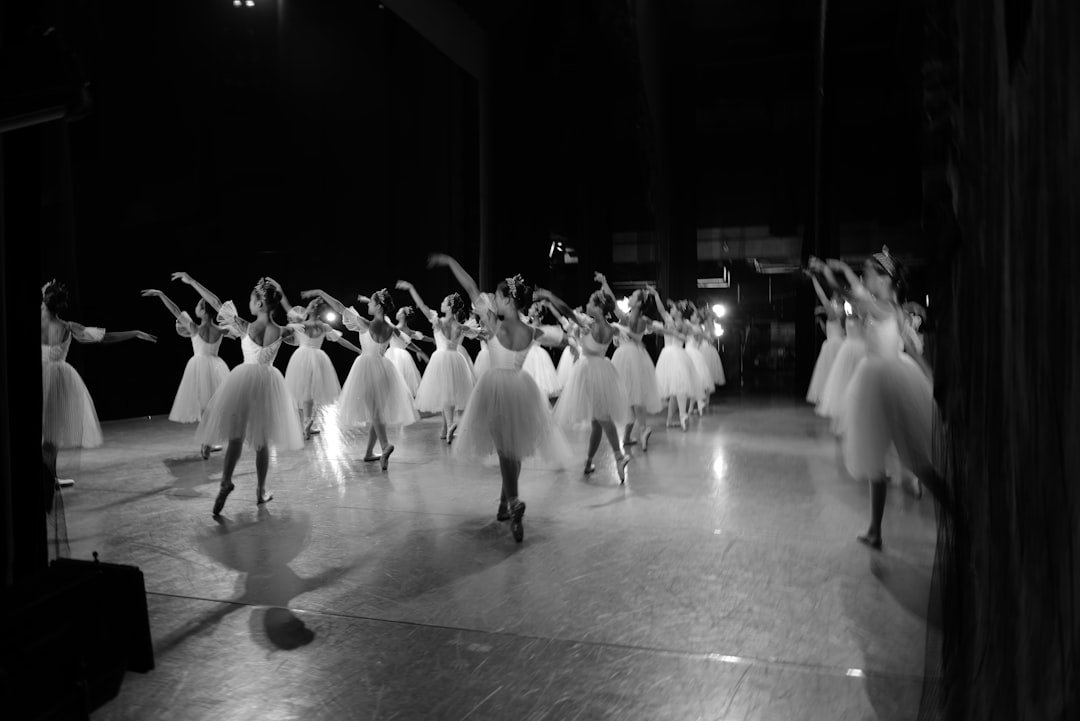 Ballet dancers in tutus perform on stage