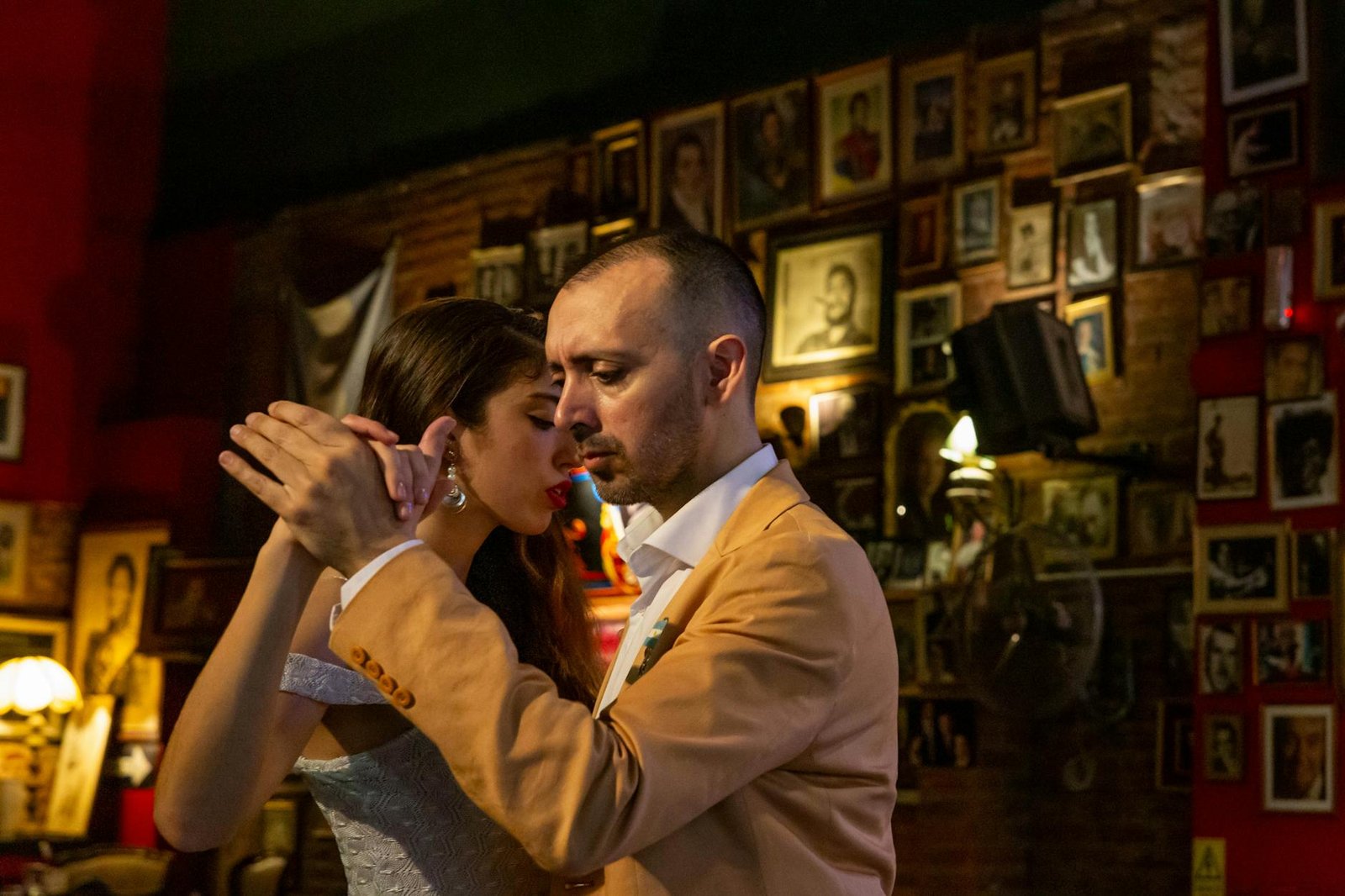 A couple deeply engaged in a passionate tango dance in a cozy bar in Mar del Plata, Argentina.
