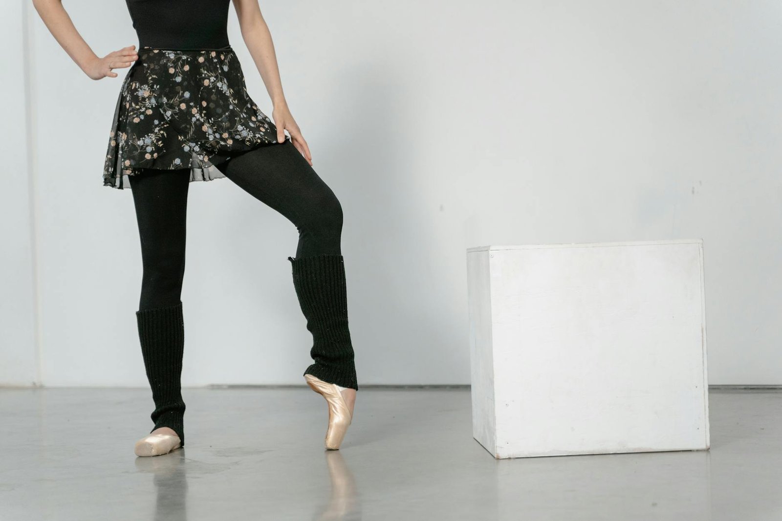 A ballet dancer elegantly posing in a studio, showcasing poise and grace.
