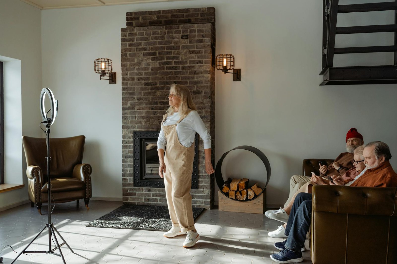 Elderly woman dances gracefully in a cozy room with friends watching, creating a warm and joyful atmosphere.