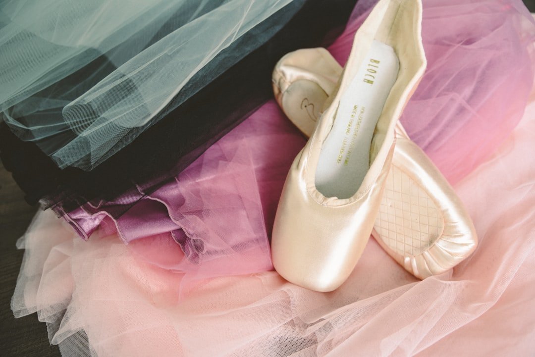 a pair of shoes sitting on top of a bed