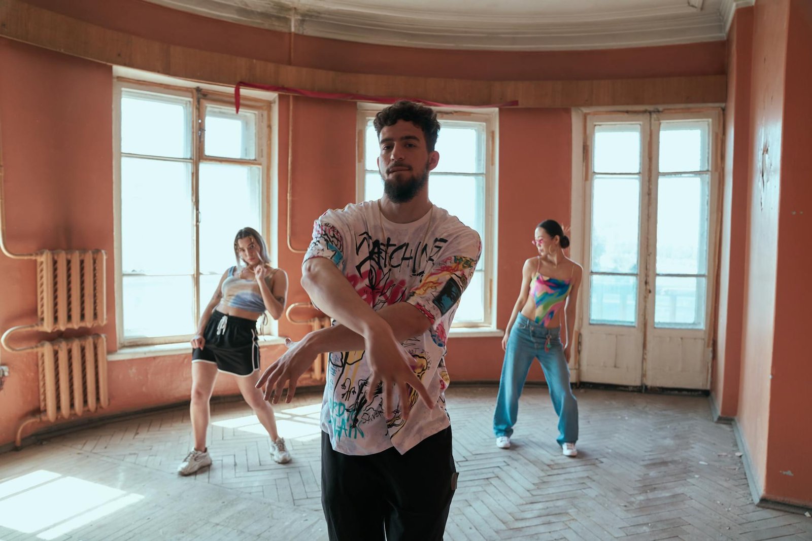 Three diverse dancers showcase hip-hop moves in a vintage styled room, exuding energy and creativity.