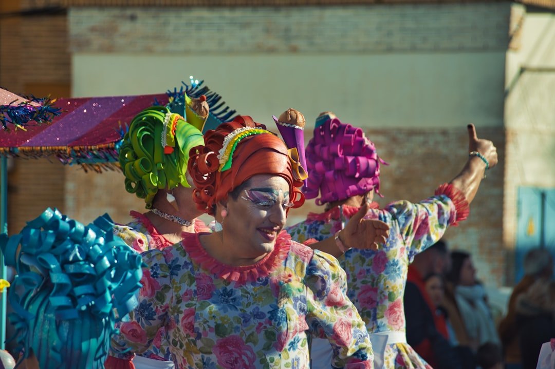 a woman in a colorful dress and headdress dancing