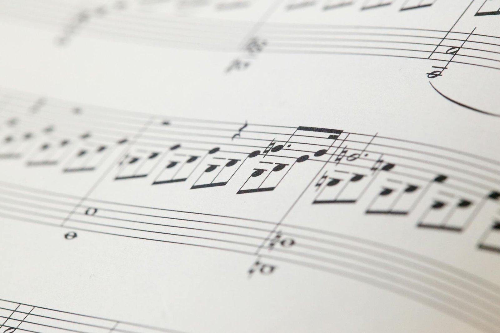 Detailed view of printed musical notes on a white sheet of paper.