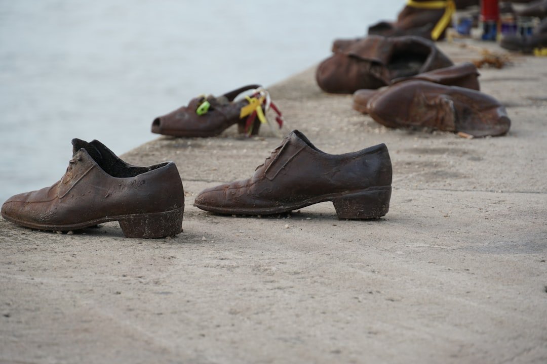 A row of shoes sitting on top of a sandy beach