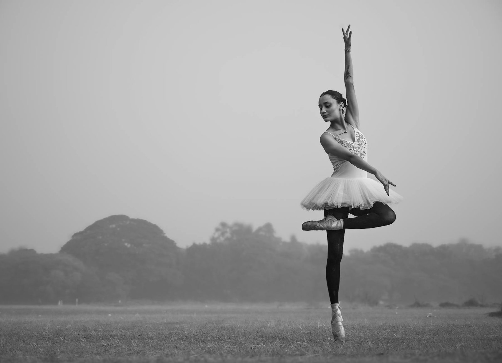 Elegant ballet dancer strikes pose in Kolkata's natural setting, showcasing poise and grace.