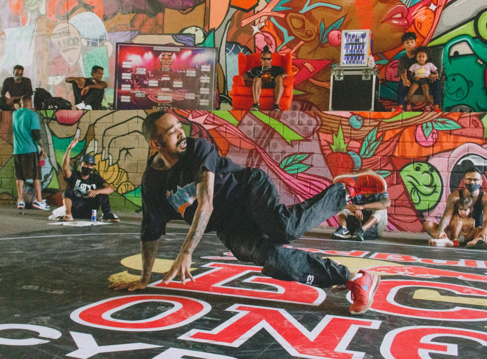 Energetic breakdancer performs on a vibrant street art backdrop. Captures the essence of hip-hop culture.