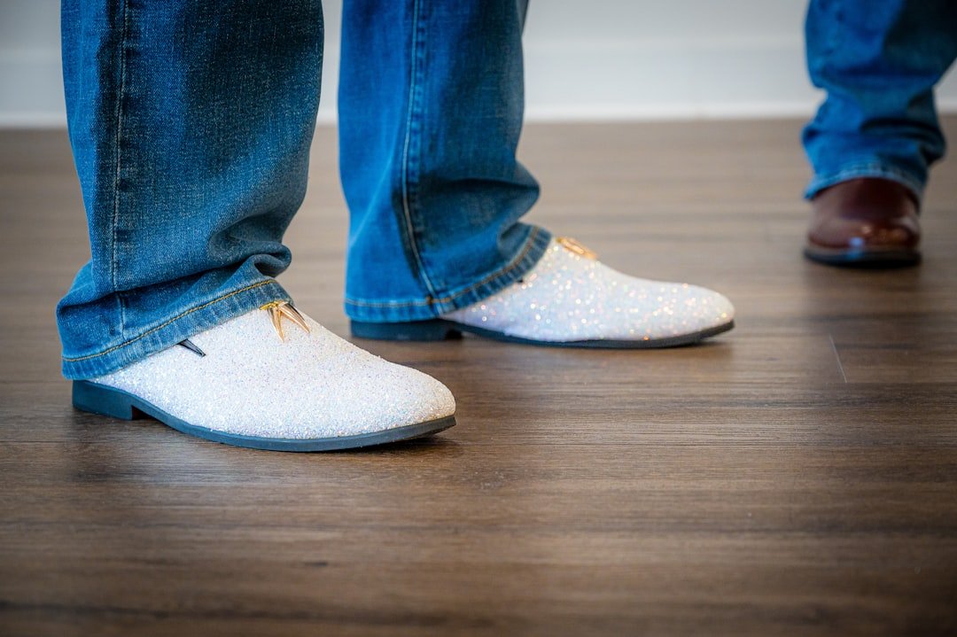 Two people wearing jeans and stylish shoes