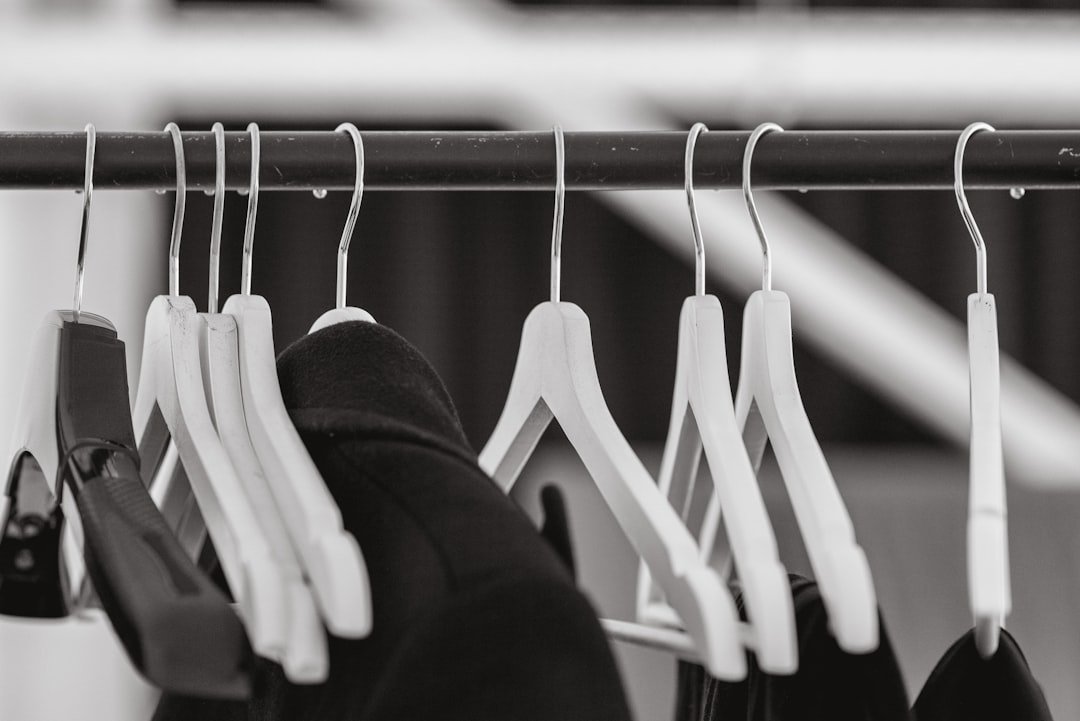 Black and white photograph of clothes hanging on a rail